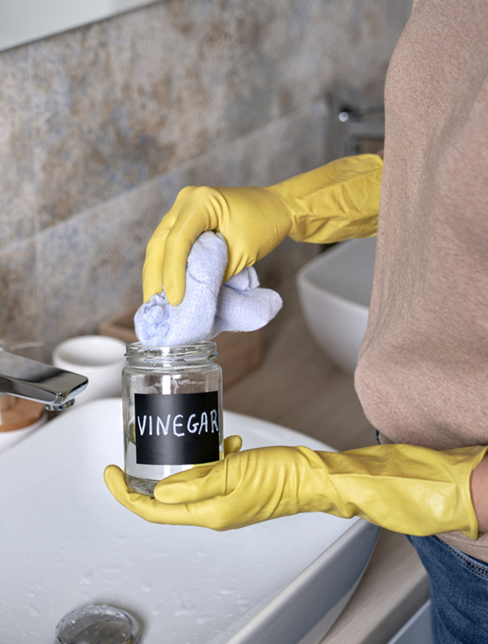 bottle of vinegar being used for cleaning - Maid Bright