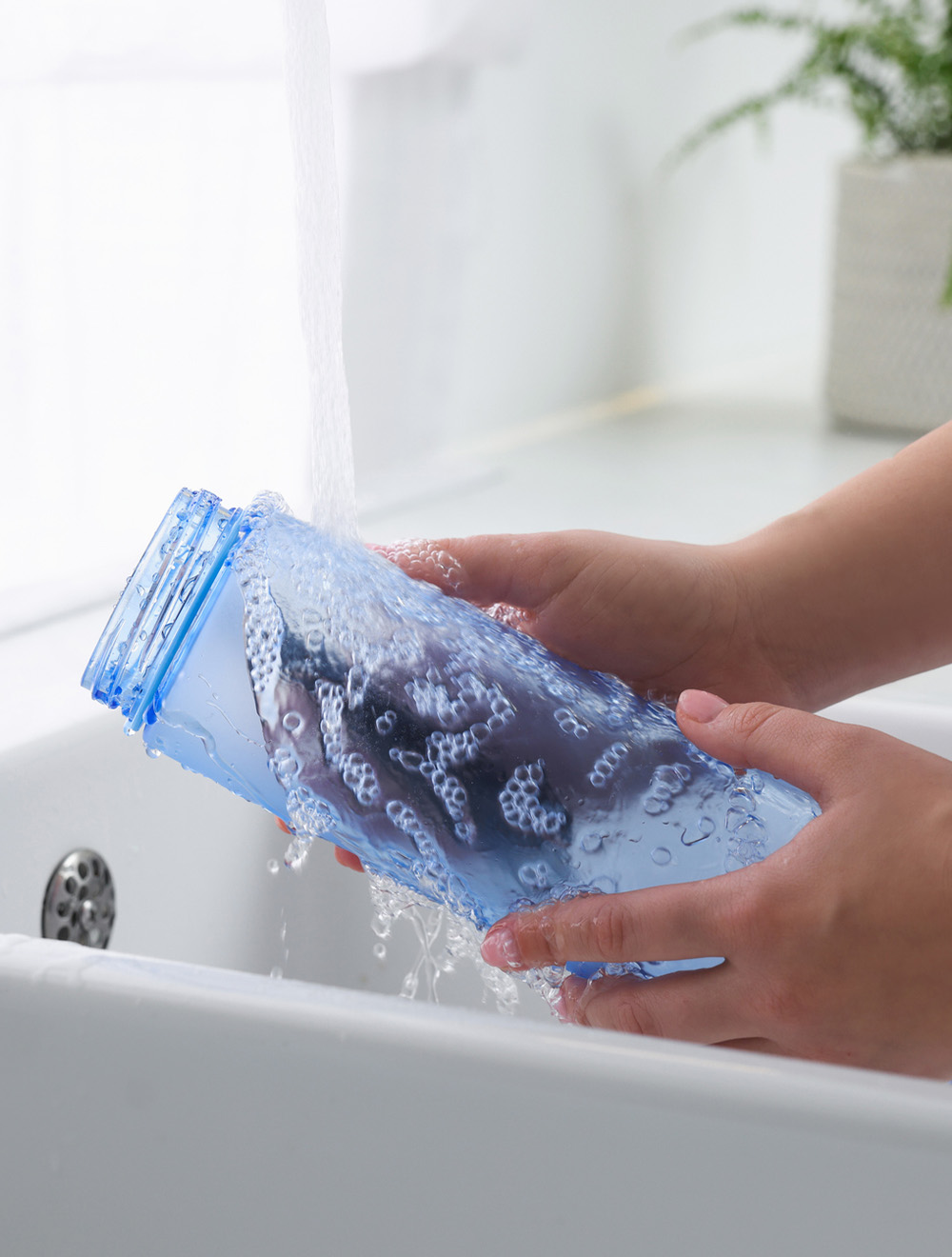 washing a reusable water bottle