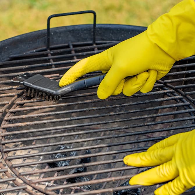 charcoal grill getting cleaned