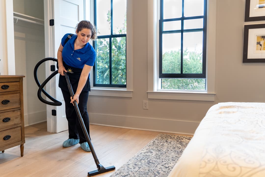 maid vacuuming carpet
