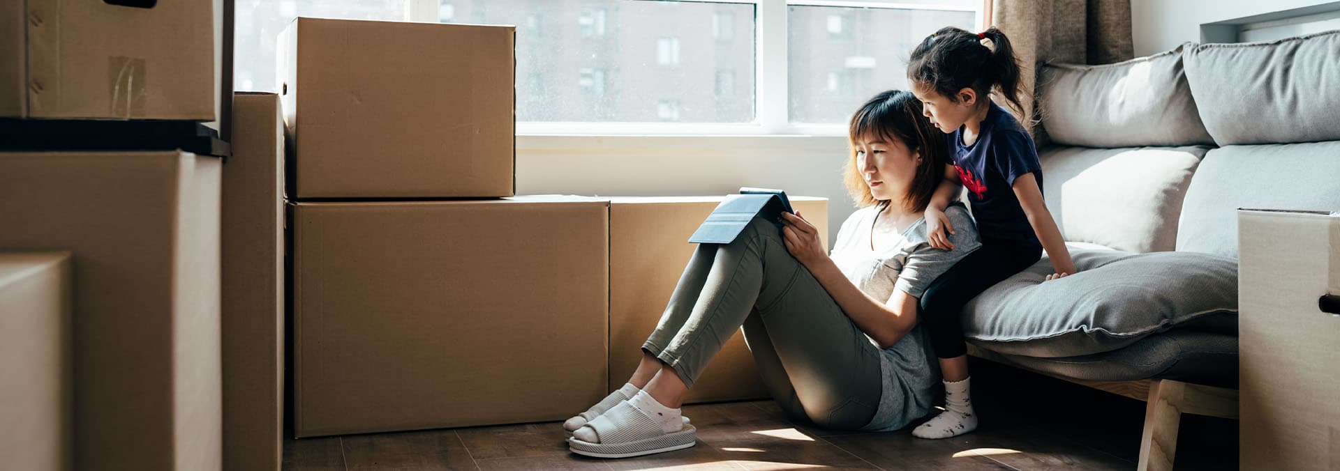 Maid-Bright-Professional-House-Cleaning-Service-Moving-Cleaning-Woman-and-Child-Moving-Boxes