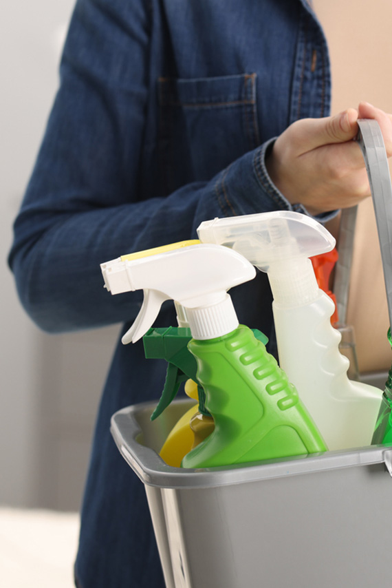 bucket holding bottles of cleaning supplies