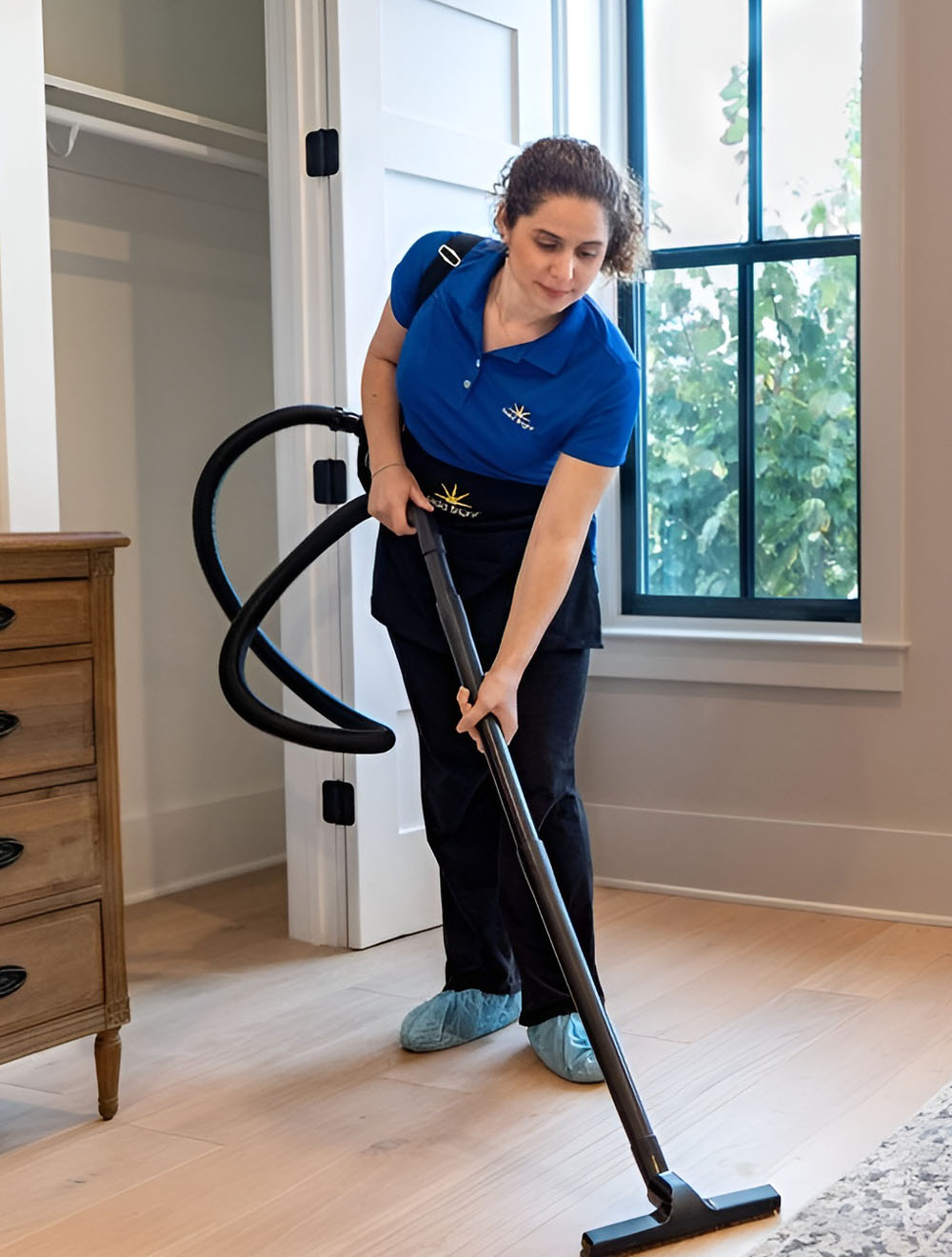 Maid Bright employee cleaning hard surface floor